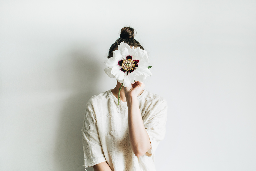 Woman hold white peony flower 