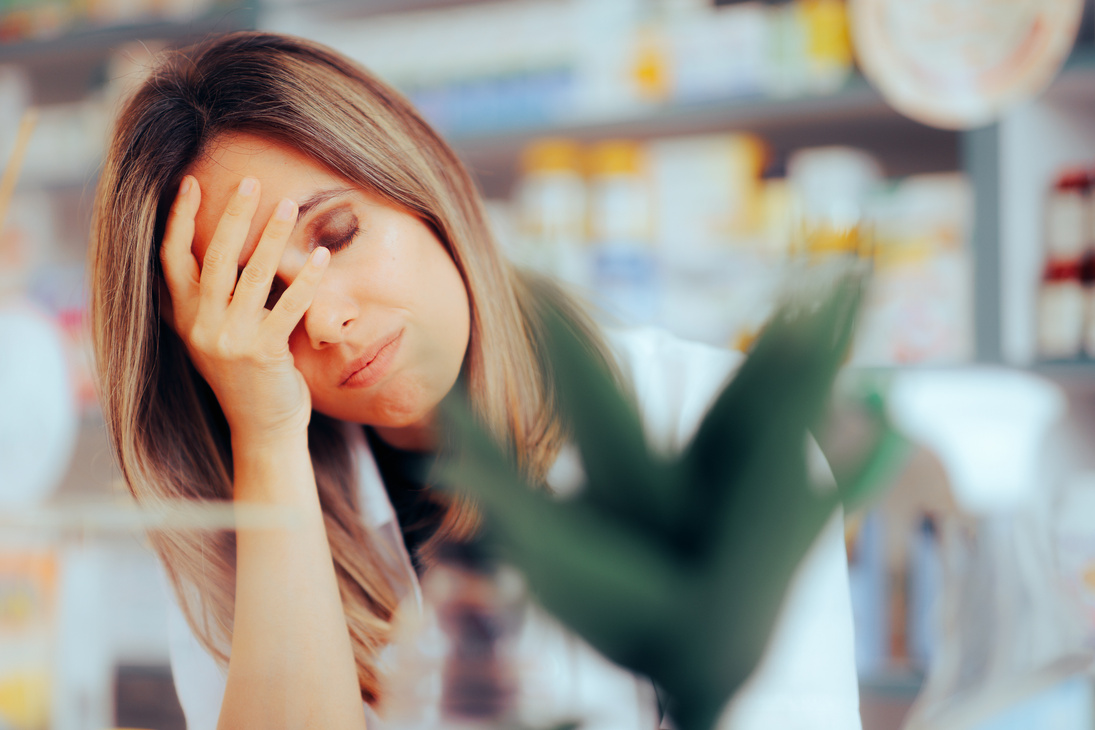 Worried Pharmacist Suffering from Headaches and Stress